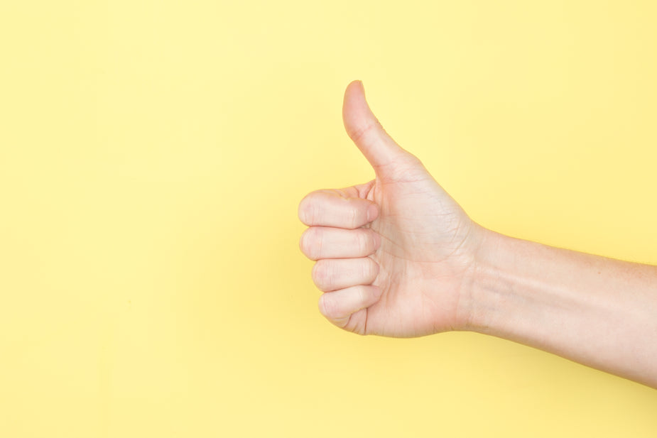 thumbs up on yellow
